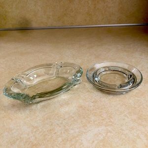 Two vintage clear glass ashtrays.